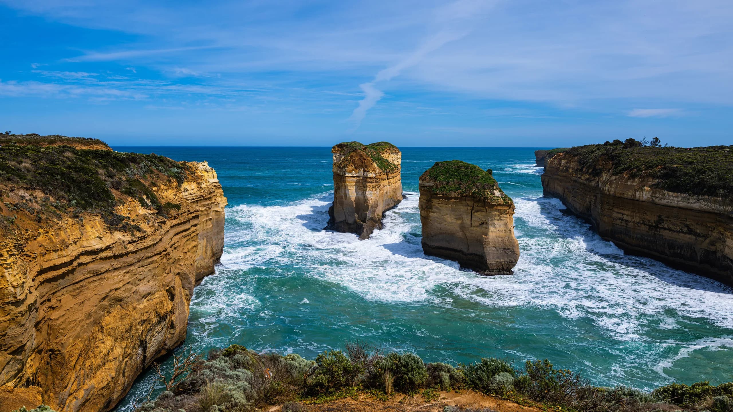 Limestone stacks and sandstone cliffs above turquoise surf on the Great Ocean Road coast